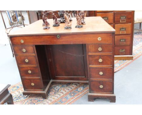 An unusual early 19th Century mahogany kneehole desk/writing cabinet with hinged top, two banks of four graduated drawers fla