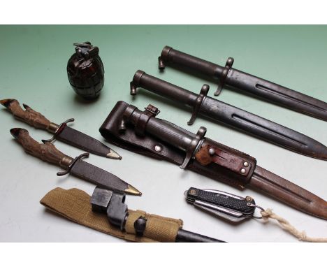 Two steel scabbard military bayonets, an Enfield stick bayonet, pocket knives and a dummy grenade