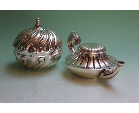 A Tiffany and Co. silver plated table light of Aladdin lamp form, and another of whorled form. (2)