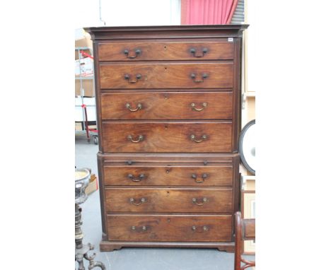 A Georgian carved mahogany chest on chest, the moulded cornice above four graduated long drawers, the lower section with brus