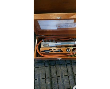 A box containing a Desoutter pneumatic multipurpose tool with various attachments.