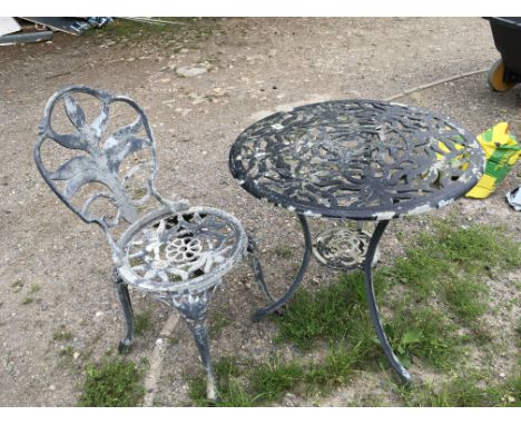 A vintage garden round table and chair