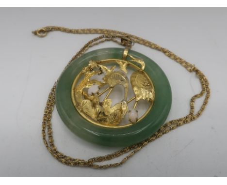 C20th Chinese circular jade pendant with inset gold plated open work study of storks with two mounted opals on chain L64cm 32