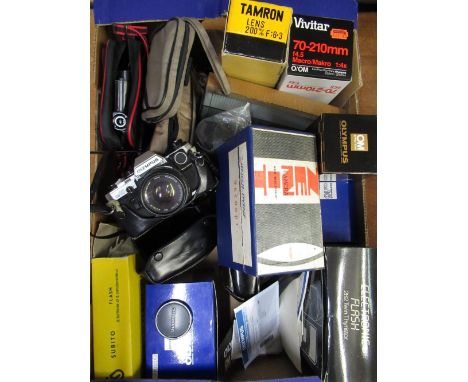 Collection of various camera equipment including an Olympus OM10 with 50mm 1.8, manual adapter, various flash guns and lenses