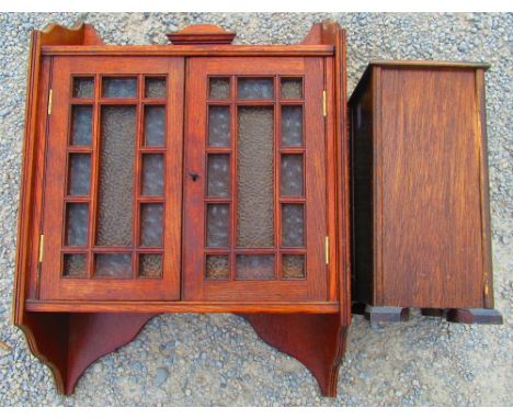 Edwardian oak wall cabinet with raised back above two coloured glazed panel doors, W46cm D18cm H65cm and a small 1950's oak s