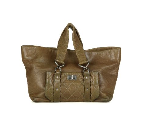 Chanel, a Reissue lambskin leather tote, crafted from khaki lambskin leather, featuring a diamond quilted front patch pocket 
