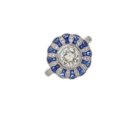 A platinum circular-cut diamond and calibre-cut sapphire dress ring, diamond weight 0.79ct, engraved to band, estimated J-K c