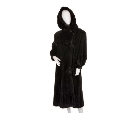 A full-length black mink hooded coat, featuring hook and eye clip fastenings, fitted cuffs, a large fur-lined hood that folds