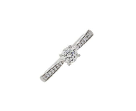 A platinum brilliant-cut diamond single-stone ring, with similarly-cut diamond line shoulders, principal diamond estimated we