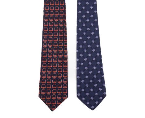 Two silk designer ties, to include a blue camellia patterned tie by Chanel, and a navy blue tie by Gucci featuring red stirru