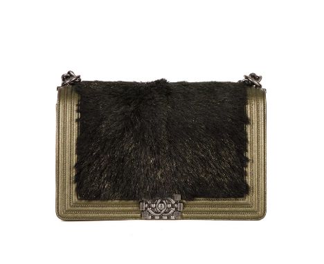 Chanel, a New Medium Boy bag, featuring a black faux fur front panel and gold leather trim, with a ribbed border, diamond-qui