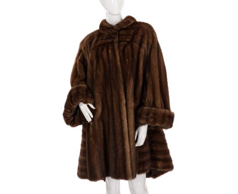 A knee-length ranch mink swing coat, featuring a short collar with large button detail, wide cocktail cuffs, hook and eye cli