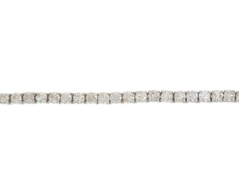An 18ct graduated brilliant-cut diamond line bracelet, with partially concealed push-piece clasp, total diamond weight 12.10c