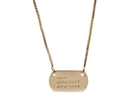 Christian Dior, a New Look 1947 dog tag necklace, the gold-tone dog tag plate impressed with 'Dior 00001947 New Look', with a