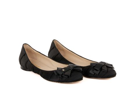 Chanel, a pair of ballerina bow pumps, crafted from black satin, featuring a layered ribbon bow detail with gold-tone CC logo