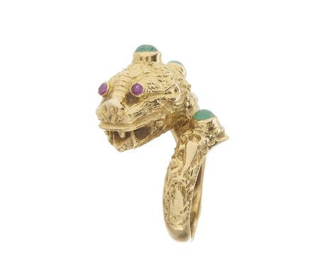 An 18ct gold green gem cabochon ring, modelled as a lion, with ruby eyes, possibly stamped 750, ring size N, 13.3gOverall goo