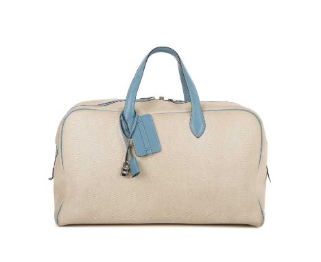 Hermes, a 2000 toile Victora GM 50 travel bag, crafted from beige toile canvas with blue leather trim, featuring dual leather