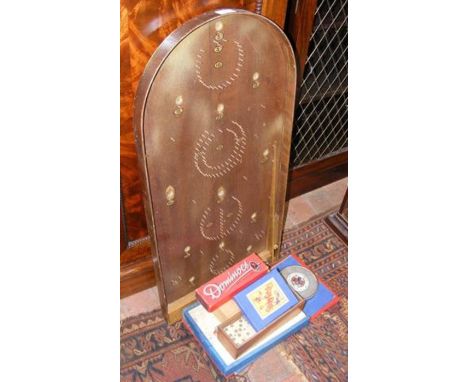 A bagatelle board together with other games