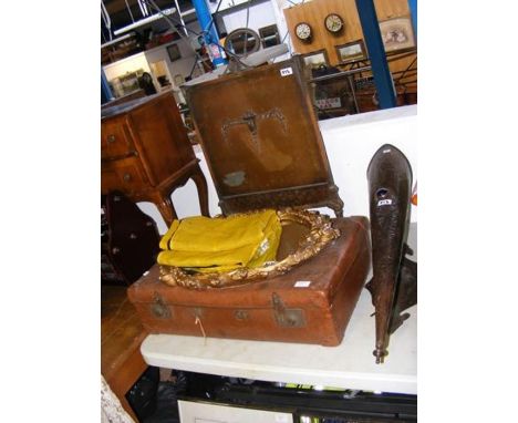 A vintage leather suitcase, gilt framed oval mirror, flag, fireguard and Arts &amp; Crafts style wall light 