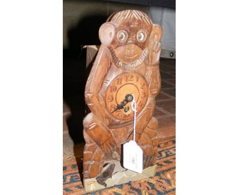 An old novelty wooden 'monkey' mantel clock with moving eyes - 25cms high