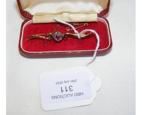 An attractive ruby and diamond heart shaped brooch in 18ct gold setting