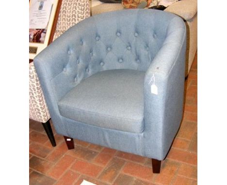 A tub armchair upholstered in light blue