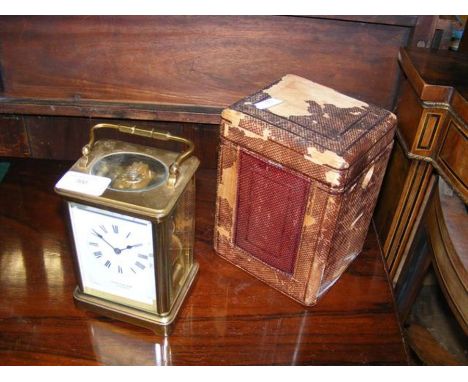 A 15cm high brass cased carriage clock with travelling case by Mappin & Webb