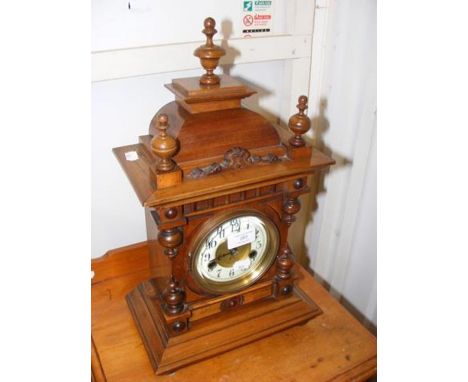 A wooden case antique mantel clock - 45cms high