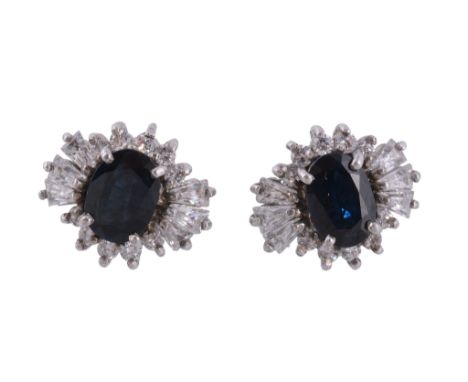  A pair of sapphire and white stone ear studs  , the oval cut sapphires within a surround of step and circular cut white ston
