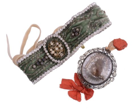  A reliquary pendant,   St Francis of Assisi, Confessor, the oval glazed locket containing a section of cloth with the inscri