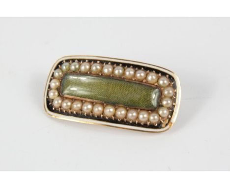 A George III memoriam brooch, of oblong shape with glazed hair locket centre and a border of seed pearls and black and white 