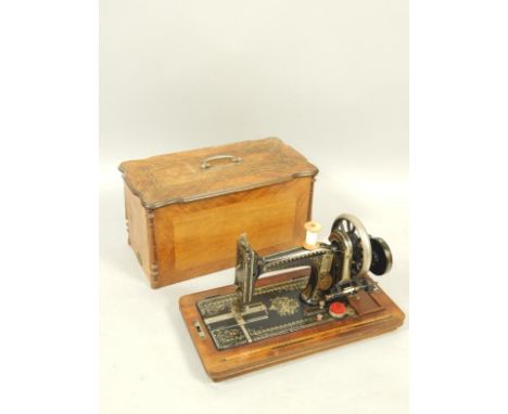 A Gritzner Durlach sewing machine, with mother of pearl inlay, wooden cased.