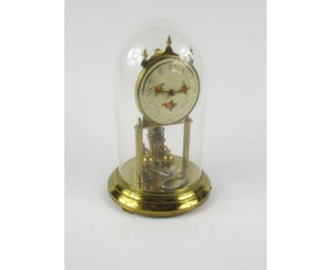 A Kundo 400 day torsion clock, cream enamel dial decorated with flowers, bearing Arabic numerals, movement by Kieninger & Obe