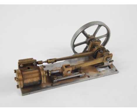 A part scratch built table top engine, with chrome finished fly wheel, 10cm diameter, and brass mounts on a plain metal base,
