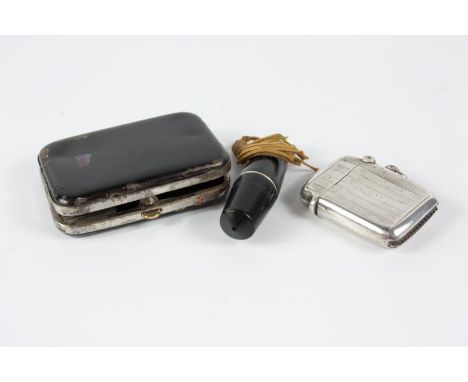 An Air France folding cigarette holder, in case, and two vesta cases, including one silver case, Birmingham 1910, (3).