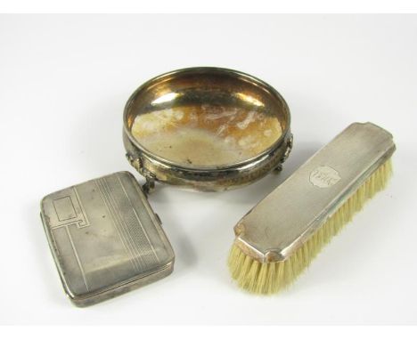 A George V silver pocket cigarette case, with engine turned decoration, Birmingham 1934, a silver backed brush, Chester 1934,