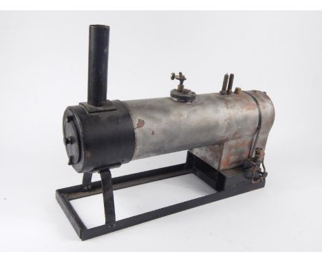A 20thC scratch built table top engine formed as a train cylinder front, with articulated brass pieces on brass metal base, u