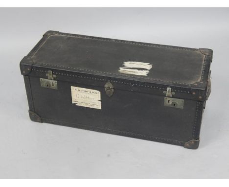 An A Potterton black travelling trunk, with leather carrying handles, 78cm x 31cm x 31cm.