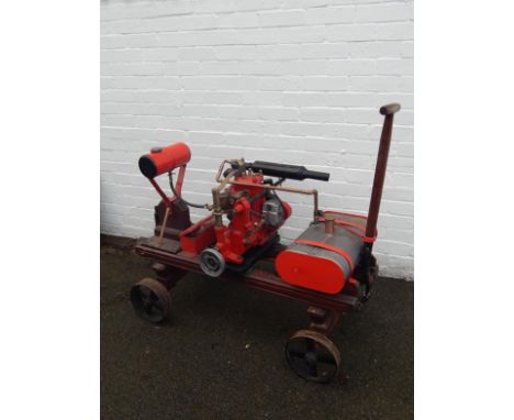 A 1930s or 1940s Stuart reverse grip marine engine no. 41R065,  with a copper pipe running into the fuel tank and rubber pipe