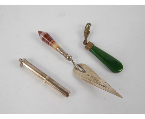 An Edwardian silver trowel book mark with agate handle, Birmingham 1906, retractable pendant, toothpick and a jade pendant fo