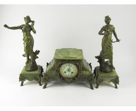 A French onyx and metal clock garniture, clock with enamel dial bearing Arabic numerals, eight day movement by Marti et Cie, 