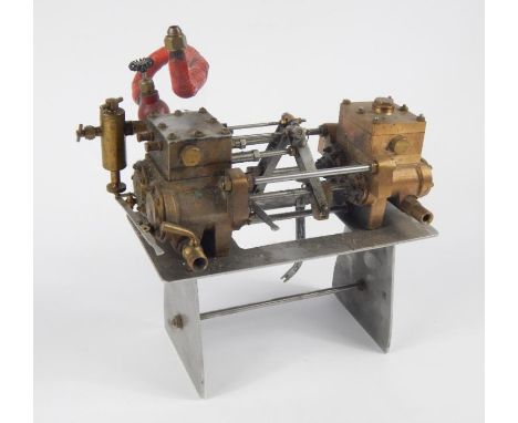 A metal cased stationary horizontal engine, with articulated pistons, brass mounts, etc, on a part pierced stand, the base 23