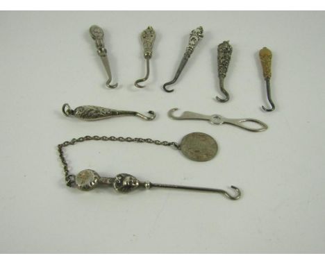 Eight small button hooks, including a silver skeleton hook.