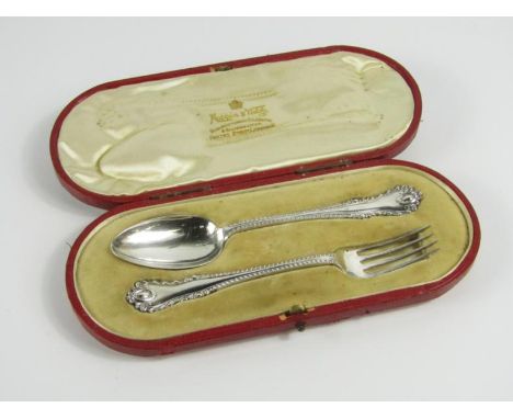 An Edwardian silver christening set, comprising a spoon and fork, with cameo and gadrooned patterned handles, Sheffield 1903/