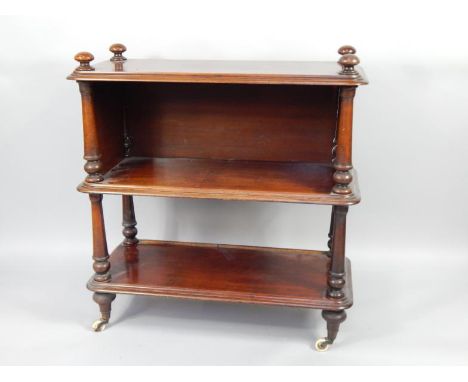 A Victorian mahogany three tier buffet, with turned supports and feet, on ceramic castors, 107cm x 47cm x 108.5cm.