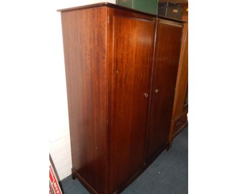 A Stag mahogany double wardrobe, raised on a bracket base, 125cm x 59cm x 177cm.