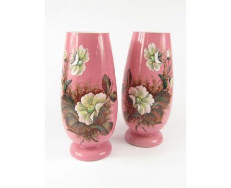 A pair of Continental late 19thC pink cased glass vases, of footed ovoid form enamel decorated with flowers, 31.5cm high.