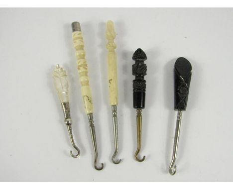 Two Whitby jet handled button hooks, a silver button hook with mother of pearl handle and two with bone handles.