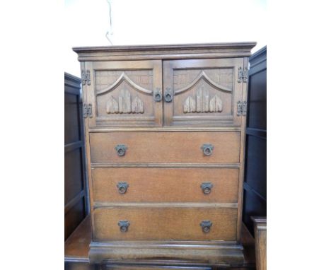 An Old Charm oak linen press, with a pair of linenfold panelled doors over three long drawers, raised on a bracket base, 81cm