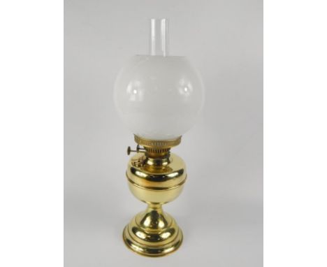 A Duplex brass oil lamp, with a circular white glass shade, two burners, 50cm high.